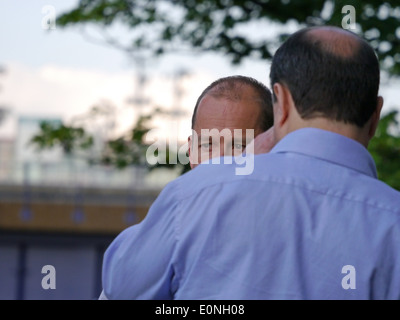 Two men talking over a drink after work Stock Photo