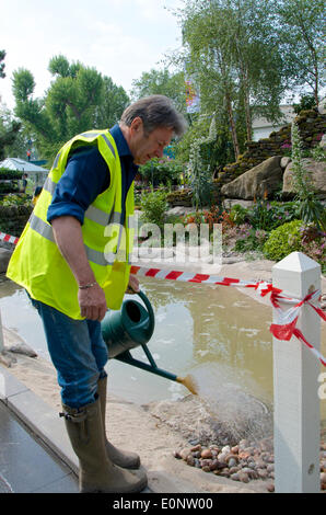 London, UK. 17th May, 2014.  Alan Titchmarsh puts finishing touches to the garden he has designed for RHS Chelsea Flower Show 2014 in collaboration with Kate Gould for the 50th Anniversary of Britain in Bloom. Stock Photo