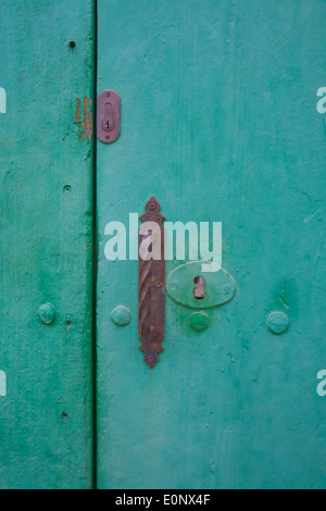 Green vintage door with old rusty locks. Mallorca, Balearic islands, Spain. Stock Photo