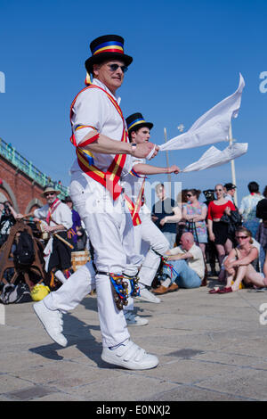 Brighton,City of Brighton & Hove, UK. Brighton's Morris Men celebrate a day of dance and beer tat Brighton Seafront outside the Fisherman's Museum, Kings Arches, Brighton, East Sussex, UK. This scene shows members of Mad Jack's Morris performing to crowds. 17th May 2014. David Smith/Alamy News Stock Photo