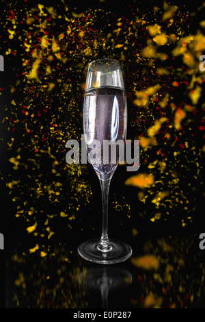 Flute of Champagne surrounded by confetti Stock Photo