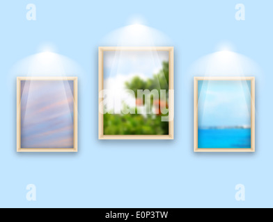 Three frames with photos hanging on wall Stock Photo