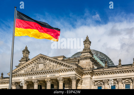 The German federal parliament with German flags, Berlin, Germany Stock Photo