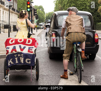 London, UK. 17th May, 2014. Cyclists pedaling during the Tweed Run on Saturday, 17 May 2014, London, UK. The London Tweed Run is a ten-mile charity bicycle organized in aid of the London Cycling Campaign where riders togged up to the nines in 1920s and 1930s cycling gear pedal around iconic London locations. Credit:  Cecilia Colussi/Alamy Live News Stock Photo