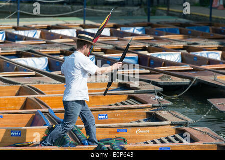 Cambridge UK , 18th May 2014. Staff at Scudamore's Boatyard prepare the punts for a busy Sunday punting on the River Cam, Cambridge UK as another warm sunny day is forecast.  The temperature is expected to reach 24 degrees centigrade.  Many tourists will take chauffeured punt trips along the river enjoying the sights of the historic University buildings.  Credit Julian Eales/Alamy Live News Stock Photo