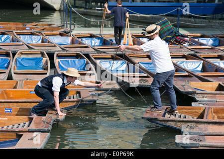 Cambridge UK , 18th May 2014. Staff at Scudamore's Boatyard prepare the punts for a busy Sunday punting on the River Cam, Cambridge UK as another warm sunny day is forecast.  The temperature is expected to reach 24 degrees centigrade.  Many tourists will take chauffeured punt trips along the river enjoying the sights of the historic University buildings.  Credit Julian Eales/Alamy Live News
