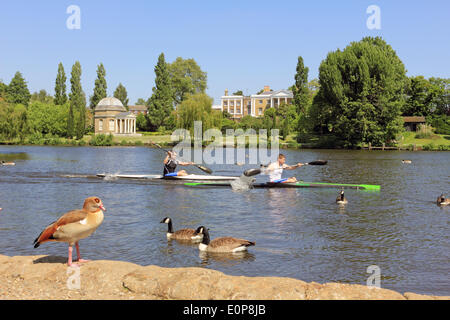 Hurst Park, Molesey, England, UK. 18th May 2014. It was sunny day across the UK with temperates reaching 24 degrees celsius making it the hottest day of the year. Here on the Thames to men paddle their canoes past Garrick's Temple at Hampton. Credit:  Julia Gavin/Alamy Live News Stock Photo