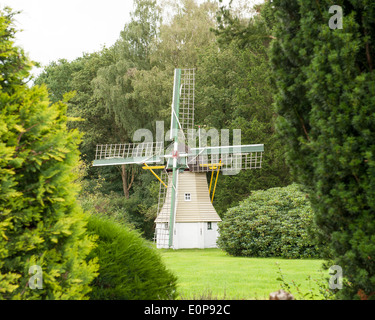 Traditional Dutch wooden windmill in forest scenery Stock Photo