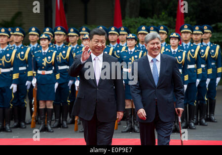 Shanghai, China. 18th May, 2014. Chinese President Xi Jinping (L) holds a welcoming ceremony for visiting Kyrgyz President Almazbek Atambaev before their talks in Shanghai, east China, May 18, 2014. Credit:  Huang Jingwen/Xinhua/Alamy Live News Stock Photo