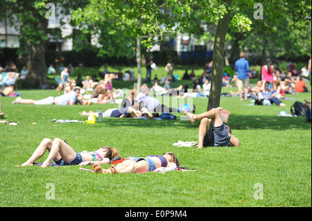 Green Park, London, UK. 18th May 2014. People sunbathing in Green Park on a hot Sunday afternoon. Credit:  Matthew Chattle/Alamy Live News Stock Photo