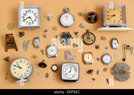 Retro alarm clocks, watches and parts for mechanical watches on old paper Stock Photo