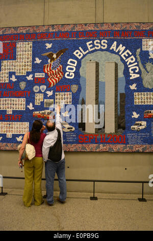 New York, NY, USA. 16th May, 2014. Couple looking at a memorial quilt at the newly opened 9/11 Museum at Ground Zero in New York City. Credit:  Christopher Penler/Alamy Live News Stock Photo
