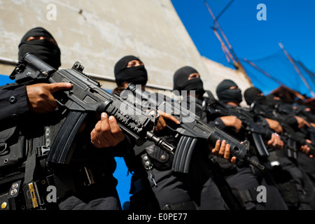 Members of the specialized Police anti-gang unit pose for pictures before leaving for an operation in San Salvador, El Salvador. Stock Photo