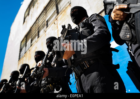 Members of the specialized Police anti-gang unit pose for pictures before leaving for an operation in San Salvador, El Salvador. Stock Photo