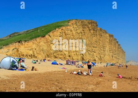 West Bay, Dorset, UK, 18th May 2014: Crowds flock to West Bay to enjoy one of the hottest days of the year on the beach where key scenes in the popular TV drama Broadchurch were filmed. The show, created by Bridport based writer Chris Chibnall, is shortlisted in three categories in tonights BAFTA awards. Credit:  Tom Corban/Alamy Live News Stock Photo