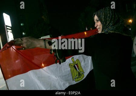 Cairo, Egypt. 18th May, 2014. A woman holds an Egyptian national flag during a rally for the presidential candidate Abdel-Fattah el-Sissi in Cairo, Egypt, May 18, 2014. Egyptians gathered here on Sunday to back Sisi's running for president over the upcoming presidential election on May 26th and 27th. © Cui Xinyu/Xinhua/Alamy Live News Stock Photo