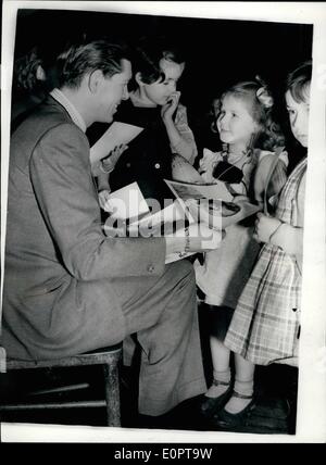 Dec. 12, 1956 - Johnnie Ray visits school for deap children : Singer Johnnie Ray this afternoon went along to the Frank Barnes school for Deaf children, central-street, city road, with a collection of toy gifts for the children. Photo shows Five year old Patricia lane, of st. Pancreas, gets an autographed picture from Johnnie Ray, when he visited the school today. Stock Photo