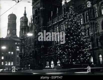 Dec. 12, 1956 - Christmas Spirit In Munich.: The huge Xmas tree just erected in front of the Munich townhall reaches to the roof of the building. In the background left the famous sign of the city of Munich the towers of the ''Frauenkirche'' can been seen. Stock Photo