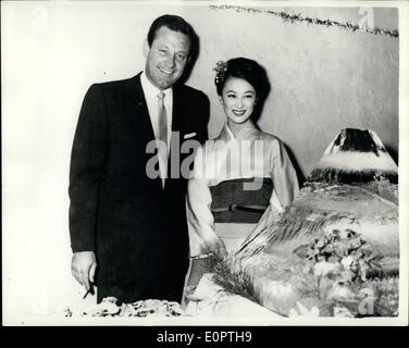 Dec. 12, 1956 - William Holden Attends Reception in Tokyo. Hollywood film star, William Holden attended a reception given in his honour at the Foreign Correspondents Club in Tokyo recently. He was enroute to Colombo, Ceylon, to play a major role in Columbia Films ''The Bridge on the River Kwai'', which will be filmed entirely in Ceylon. He is seen here with the lovely Japanese film star Keiko Kishi, who was the winner of the best actress award at the Asian Film Festival in Singapore, for her performance in ''The Refugee'' Stock Photo