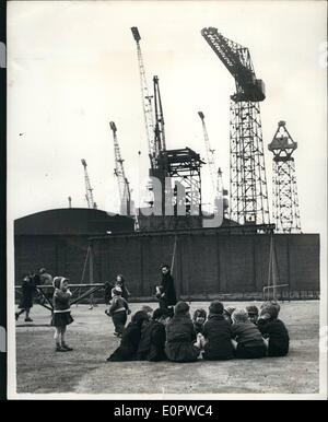 Mar. 03, 1957 - Children play in the shadow of the idle shipyards. the strike in Glasgow: Photo shows Local children amuse themselves in the playgrounds-which are overlooked by the idle cranes and machinery of the Fairfields Shipyards - Glasgow - during the strike of shipbuilders Stock Photo