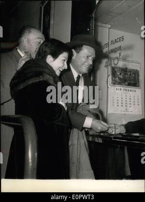 Jan. 10, 1957 - Actors see own film as spectators. Photo shows Eddie Constantine and Zizi Jeanmarie the two stars of the new film ''Folies Bergere'' get their tickets at the booking office for the premier of the film at Balzac's, Paris. Stock Photo