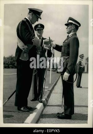 Jul. 07, 1957 - First Sea Lord takes salute at R.A.F. passing out parade. Sword of honour to best all-round cadet: Earl Mountbatten of Burma - the Admiral of the Fleet - was the review officer today at the passing out Parade of No. 70 Entry - The Royal Air Force College, Cranwell. Photo Shows Earl Mountbatten presents the Sword of Honour to senior Under Officer T.E. Enright of Dunedin, New Zealand - at the Parade today. Enright also received the R.M. Groves Memorial Prize - and the Queen's Medal. He is to serve with the New Zealand Air Force. Stock Photo
