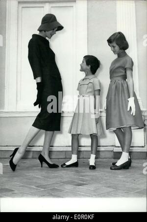 Jul. 30, 1957 - Dress and young mannequins: Two youthful mannequins, Martine and Frederique, model ''Town and Sports'' dressed designed by Virginie for her autumn and winter collections. Stock Photo