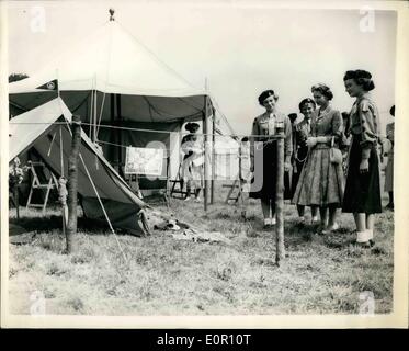 Aug. 08, 1957 - Queen visits girl guides world camp - at Windsor. Gift for Prince Charles and Princess Anne.: H.M. The Queen visited the World Camp for Girl Guides in Windsor Great Park today. Photo shows H.M. The Queen looks at a gift of a hand-made tent - complete with cooking equipment - cutlery - plates etc. which she received from the British Guides as a gift for Prince Charles and Princess Anne - at the camp this morning. Stock Photo