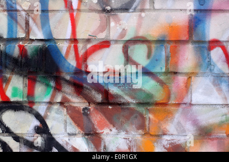 Colored graffiti textured background on the brick wall Stock Photo