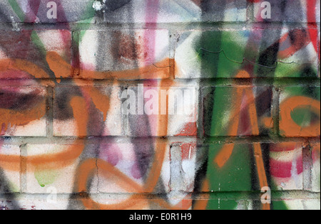 Colored graffiti textured background on the brick wall Stock Photo