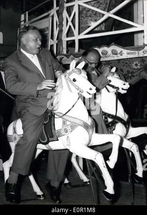 Sep. 06, 1957 - It Is Fun to Ride a Merry Go Round When Colored Ponies Go Around. Children and grown ups like to have fun and Professor Forssmann who had been awarded the Nobel Prize take a ride during break of his working day at a fair in Bad Kreuznach (You see him in our picture in the foreground. Keystone Picture of Sept 6, 1957. Stock Photo