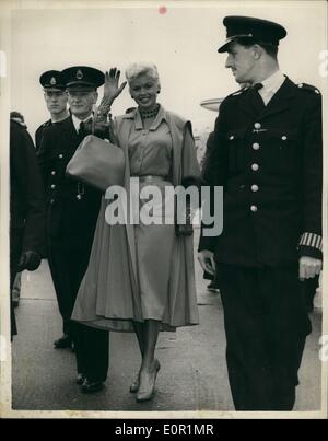Sep. 09, 1957 - Jayne Mansfield Arrives: Hollywood film star Jayne Mansfield arrived at London Airport today. She is to attend tomorrow's premiere of her film ''Oh! for a Man!'' Photo shows There was a police escort for Jayne Mansfield when she walked from the plane - at London Airport today. Stock Photo
