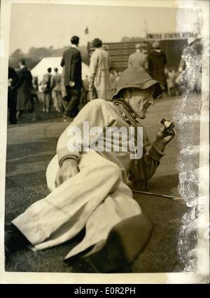 Oct. 10, 1957 - ''Mac'' takes the easy on the golf course. Ryder cup golf contest. Popular figure on the lindrick golf club Yorkshire - during the Ryder cup contest - was ''Mac'' - actually sixty one year old Harold James Burk of county cork. He is the eccentric caddies to Max Faulkner. ''Mac'' is seen here wearing Max Faulkner's blue Ryder cup jersey and a soft red felt hat as he takes it easy. He watches every shot through his opera glasses. Stock Photo