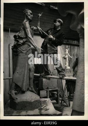 Nov. 11, 1957 - Mr. McFall At Work On The St. Bride And St. Paul Statue - In London: The sculptor Mr. David McFall is now at Work on the statues of St. Bride and St. Paul which are to be a feature of the St. Bride's Church. Fleet Street- which is to be re-opened in presence of H.M. The Queen on December 19th. Photo shows Mr. David McFall at work on his statue of ''St. Bride'' - at his Chelsea Studio. Stock Photo