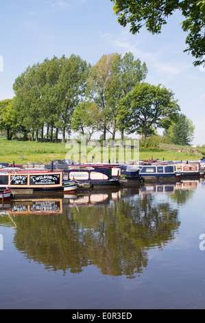 Canal narrow boats moored on the Leeds and Liverpool canal  near Barnoldswick marina, Lancashire, UK Stock Photo
