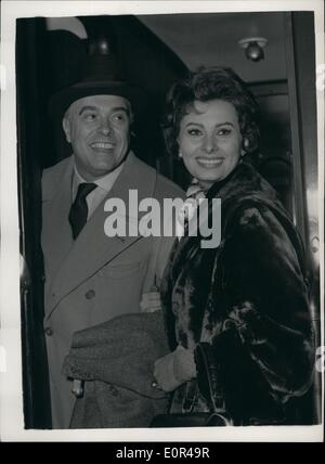 Dec. 12, 1957 - Italian film star leaves for holiday in Switzerland, Sophia Loren at Victoria: Among the passengers leaving Victoria station on the Golden Arrow boat train this afternoon was Italian screen star Sophia Loren who has been filming here. She is to spend Christmas with her husband Carlo Ponti in Switzerland. Photo Shows Sophia Loren and her husband Carlo Ponti they left Victoria station this morning. Stock Photo