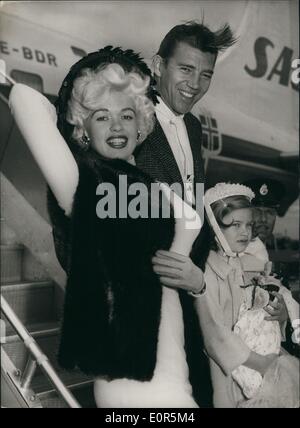 Apr. 04, 1958 - Jayne Mansfield Arrives: Jayne Mansfield, the Hollywood star, arrived at London Airport today. She is to co-star with Kenneth More in the film ''The Sheriff of Fractured Jaw''. She was accompanied by her husband, Mickey Hargitay, and her daughter, Jayne. Photo shows Jayne Mansfield, withe her husband, Mickey Hargitay and her daughter , Jayne, on arrival at London Airport today. Stock Photo