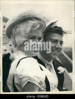 May 05, 1958 - Jayne is off to Spain.: Photo shows Hollywood film star Jayne Mansfield pictured at London Airport yesterday with her husband, Mickey Harcitay, when they left for Madrid, where Jayne is to make the film ''The Sheriff of Fractured Jaw'', with the British film star Kenneth More. Stock Photo