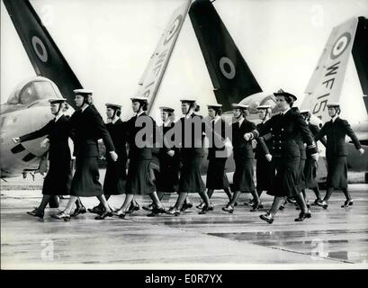 Jul. 13, 1958 - 13.7.58 Wrens take part in comedy film. A party of members of the Women's Royal Naval Service, seen marching across the airfield at Les-on-Solent air station yesterday, during a scene for the new British comedy film Further Up the Creek . The scene called for the slipstream from a jet engine to blow the uniforms off, but the real Wrens were not used for this, their places were taken by young models Stock Photo