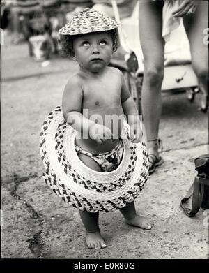 Jul. 15, 1958 - Now What's Happened. Photo Shows 14 Months old Trevor Wood, of North Shields, Northumberland, just happened to give his straw sunhat a pull and the brim came away and slipped down to encircle him, which just goes to show that he doesn't know his own strength. Stock Photo