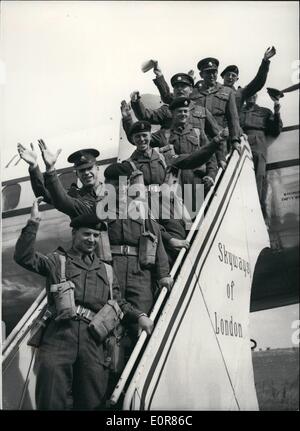 Jul. 07, 1958 - 10th Infantry Brigade Fly Out Top Cyprus: Advanced elements of the 19th Infantry Brigade were being airfield from Stansted, Essex, to Cyprus today. The Brigade consists of the 1st Battalion East Surrey Regiment, the 20th Field Regiment, R.A. and 34th Light A.A. Regiment, R.A. They will take over internal security duties in Cyprus from units new in Jordan. Photo Shows Col. Wallace and men, of the East Surrey Regiment give a cheerful wave from the steps of one of the aircraft that flew them to Cyprus today. Stock Photo