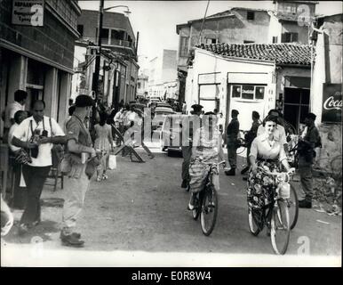 Jul. 07, 1958 - British troops keep a watchful eye on Nicosia .. Greek employees enter the Turkish quarter: Led by two girls - Greek employees of the Cyprus Government enter the Turkish quarter of Nicosia on way to work in Government offices - covered by guns of British troops. The Cyprus Government had to make special arrangements for this when Greek Civil servants went on strike because of alleged ''Inadequate protection'' against the Turks. Stock Photo