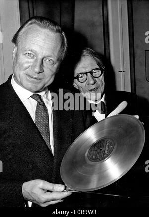 Oct 29, 1958 - Paris, France - (File Photo, location unknown) ANDRE CLUYTENS was a Belgian-born conductor who became a French citizen in 1948. He was the principal conductor of the Paris Conservatory Orchestra 1949-60. PICTURED: ANDRE CLUYTENS, left, with a gold record and gold baton he was given in homor of his 1,000,000 selling recording of Ravel's 'La Valse.' At right is pianist ALFRED CORTOT. Stock Photo