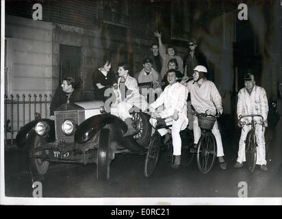 Jan. 01, 1959 - IT'S FUN TO BE YOUNG. Pedalling his cycle into Sloane Square yesterday wearing pale blue pyjamas came Lord Valentine Thynne, third son of the Marquis of Bath. Close behind him was Greville Howard, 17-year old cousin of the Earl of Suffolk, in gold pyjamas made from curtain material and a crash helmet bearing the skull and crossbones. Four other cyclist in the variety of nightshirts and pyjamas, followed. At the end of the procession came a white convertible Rolls Royce loaded with cheering debs Stock Photo