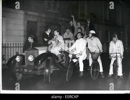 Jan. 01, 1959 - It's fun to be young: Pedaling his cycle into Sloane Square yesterday wearing pale blue pyjamas came Lord Valentine Thynne, third son of the Marquis of Bath. Close behind him was Greville Howard, 17 year old cousin of the Earl of Suffolk, in gold pyjamas made from curtain material, and a crash helmet bearing the skull and crossbones. Four other cyclists, in a variety of nightshirts and pyjamas, followed. At the end of the procession came a a white convertible Rolls Royce loaded with cheering debs Stock Photo