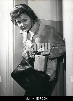 Feb. 02, 1959 - The size of a postcard... has the new flash-lighter ''Cornet' which easily can be put into a handbag. The weight is only 950 gramms. Also the men easily can carry it in the pocket. It seems to be special fit for 'photo-spies'. The loading is possible by a usual flat-iron-plug without opening the instrument. (Producer: Deutsche Elektronik G.m.b.H. Berlin - Wilmersdorf) Stock Photo