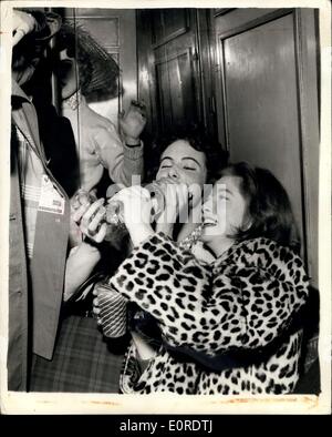 Mar. 20, 1959 - Young Chelsea Socialites Holds Bottle Party On Underground Train. Led by 24 year old Maureen Lwle-Purdy 200 members of Chelsea's 'Start'' set - held a ''Bottle'' party on the 8-3 p.m. Inner Circle train from Sloane Square. Each guest carried a bottle - a glass and an all-the-way ticket for the journey. Normal passengers protested strongly - and at South Kensington some of the revellers danced on the platform. Police arrived and the party from broken up... Keystone Photo Shows:- Some of the revellers during the party. Stock Photo