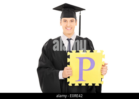 Male student holding a piece of puzzle with the letter p on it Stock Photo