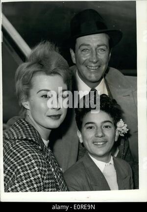 Feb. 14, 1959 - Robert Taylor and his costars leave for Africa: Screen star Robert Taylor left London Airport this afternoon for location in Africa for his new film Adamson of Africa. He was accompanied by his co stars Anne Aubrey of London and John Dimech known by all as Pasha a sixteen year old Maltese trainee waiter. Photo shows Robert Taylor Anne Aubrey and John Dimech at London Airport this afternoon. Stock Photo