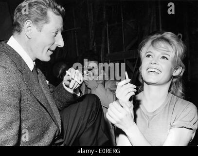 Actress Brigitte Bardot laughing with actor Danny Kaye in a Paris film studio Stock Photo